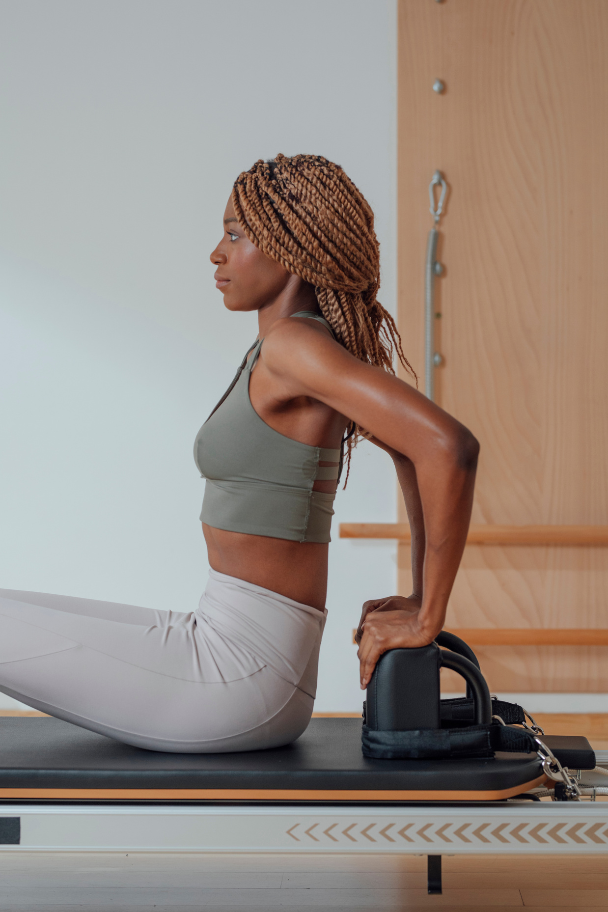 Woman Doing Pilates Exercise on Reformer