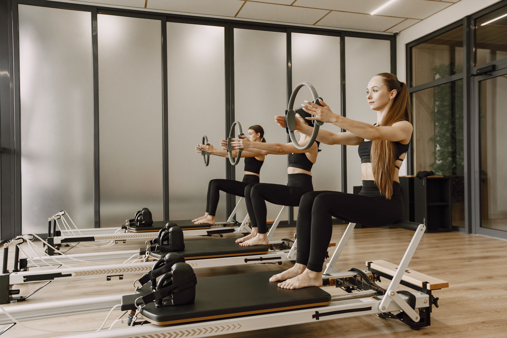 Women Exercising on Pilates Reformer Machines