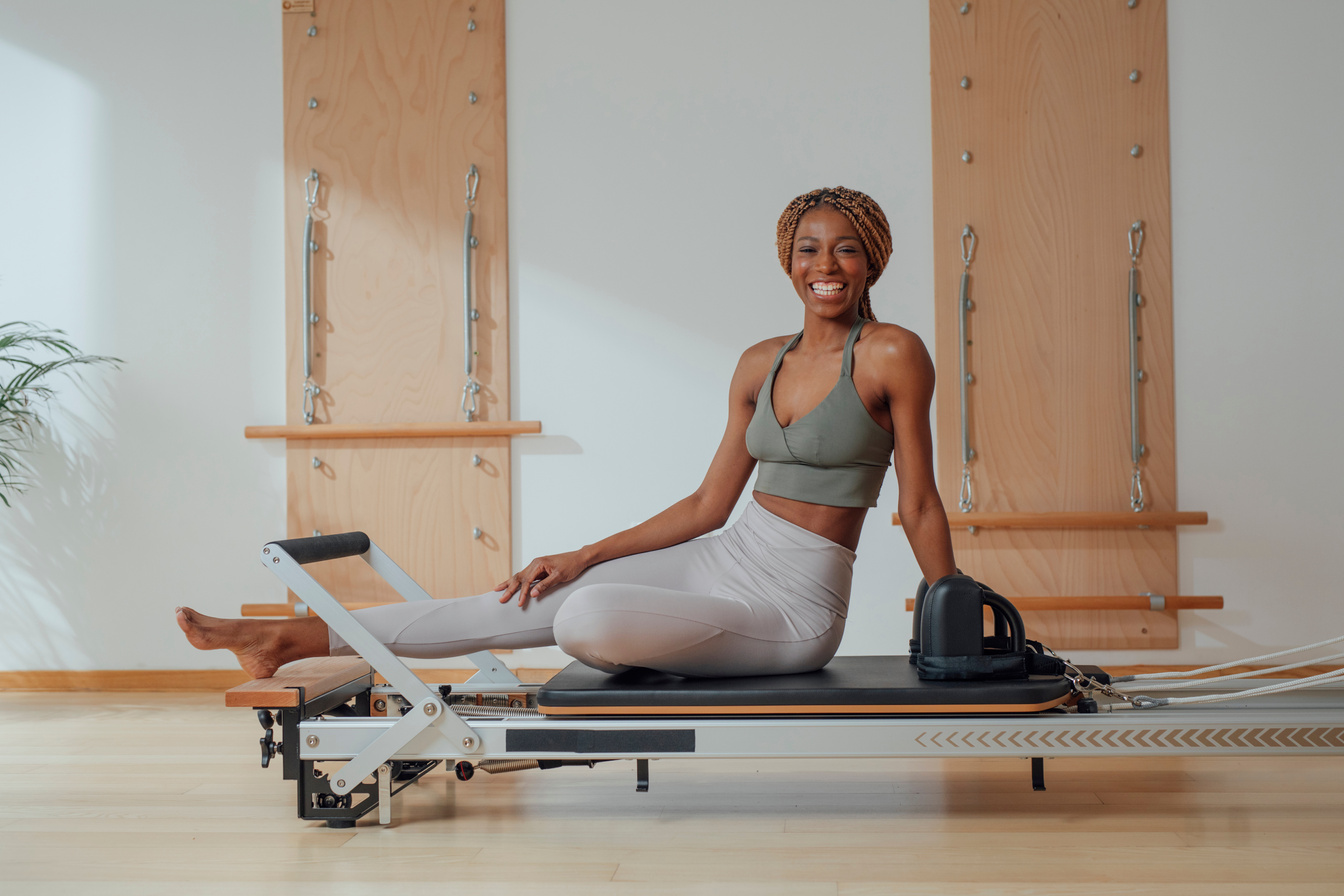 Sportswoman Practicing Pilates Reformer