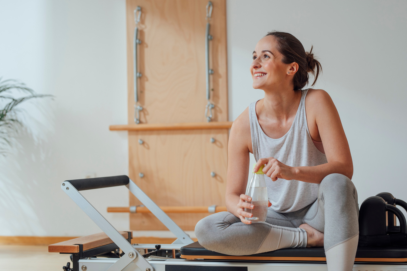 Woman Sitting on Pilates Reformer